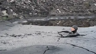 Man jump and sinking coal mud